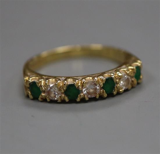 A modern 18ct gold, emerald and diamond half-eternity ring, size M/N.